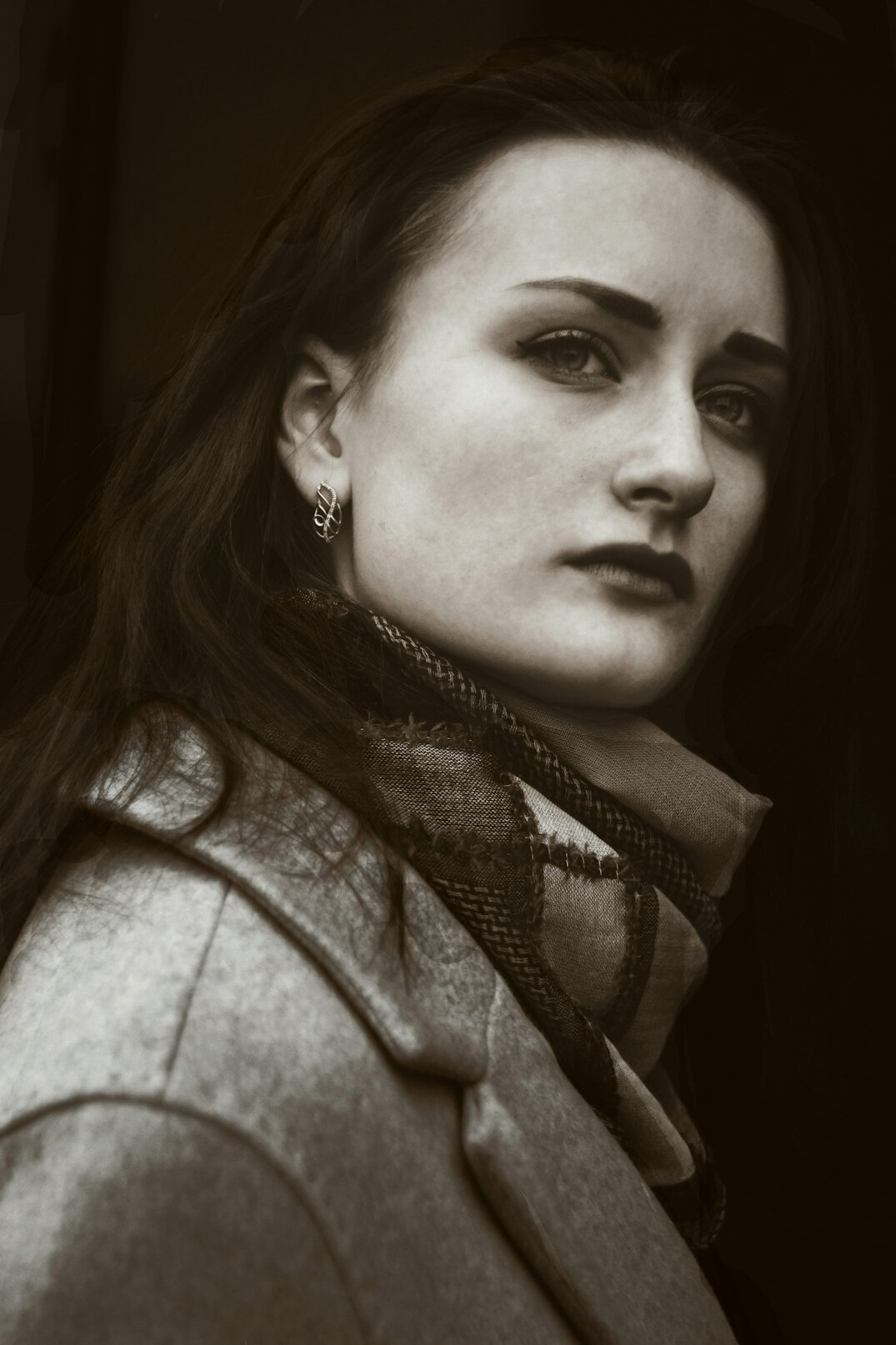 Portrait of a woman in her forties with dark hair in a blazer