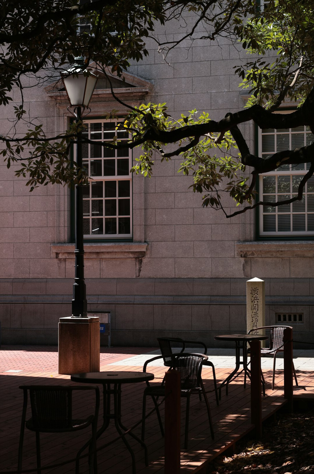 Long wooden reading table in a quiet historic archive with lamps