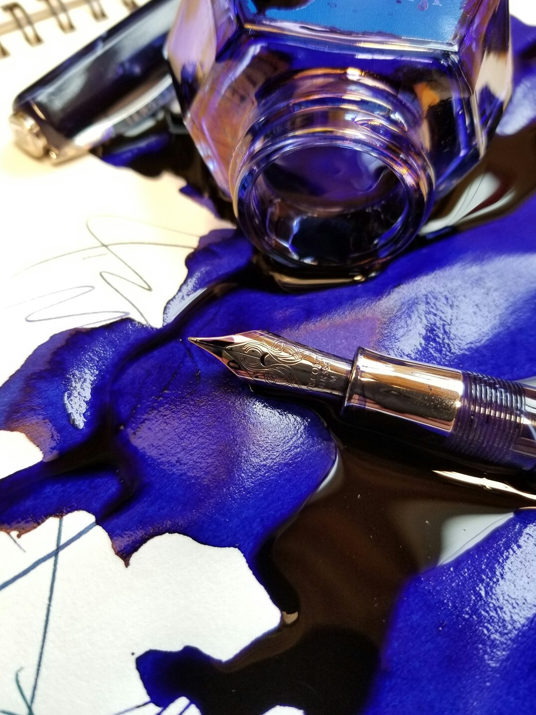 Handwritten investigation notes in ink next to a fountain pen